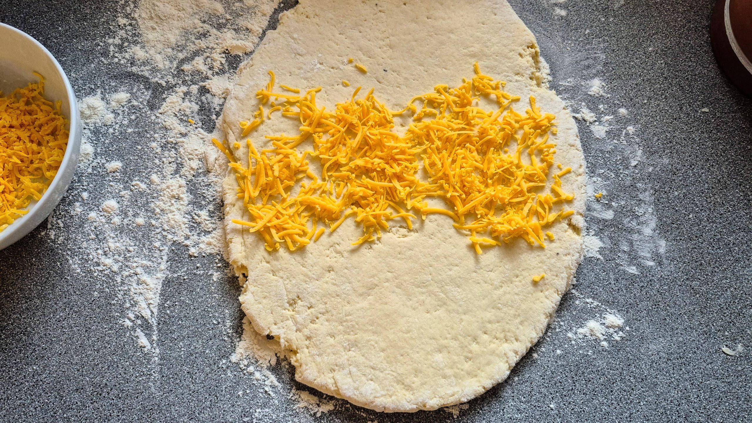 Rolled-out potato scone dough with a layer of cheese