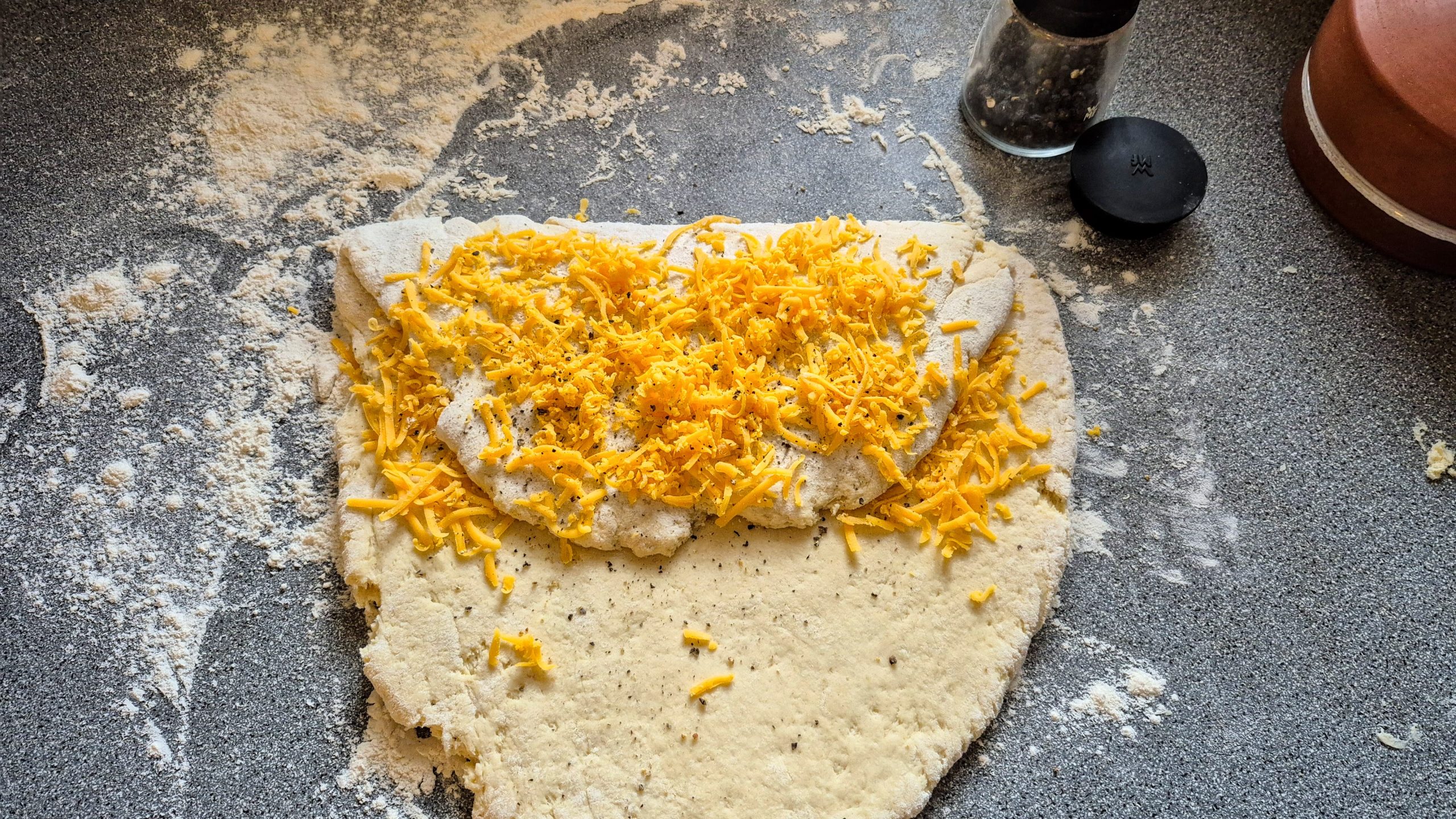 Cheese sprinkled on the folded scone dough