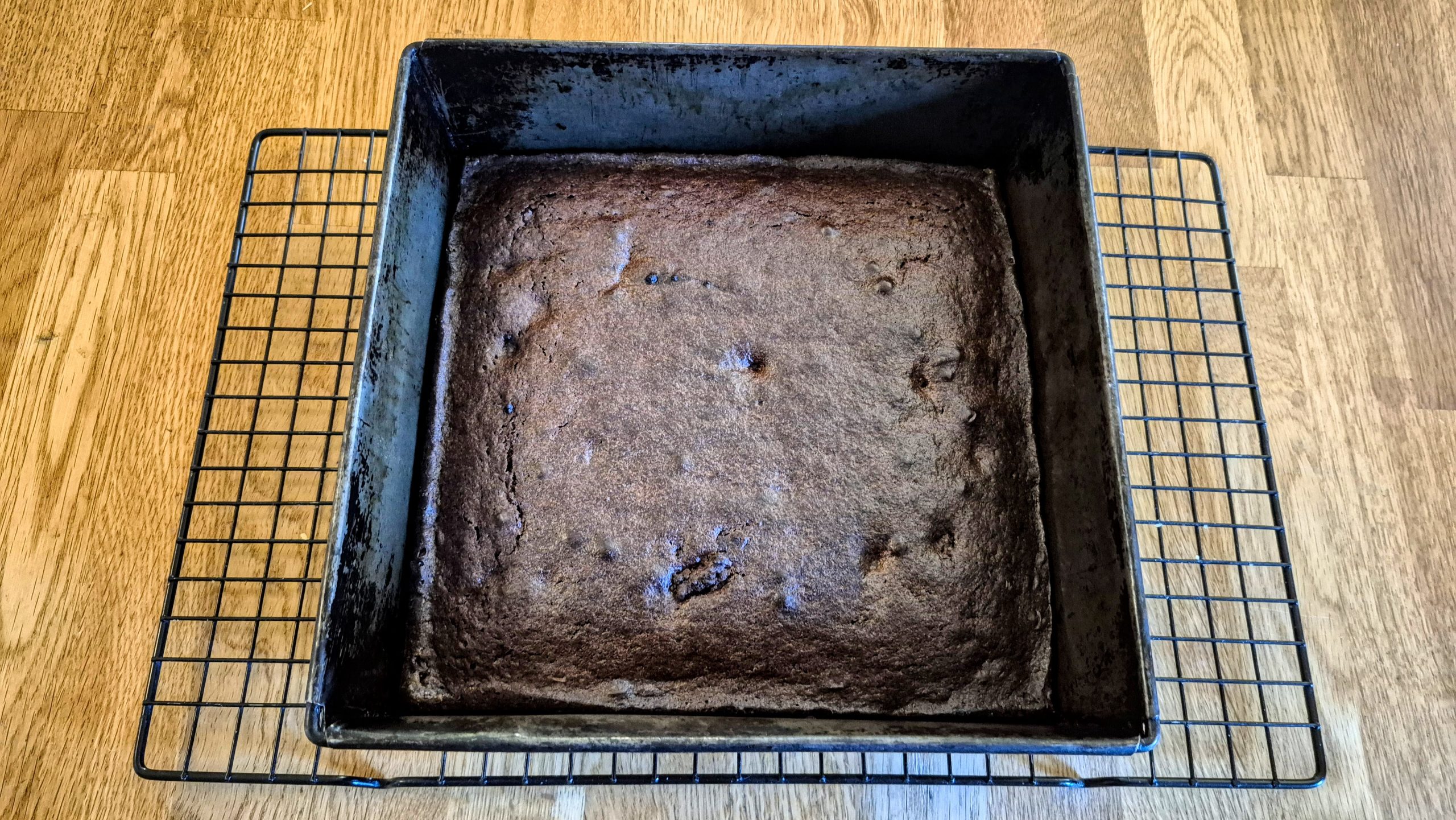 The fully-baked brownies in the pan, cooling