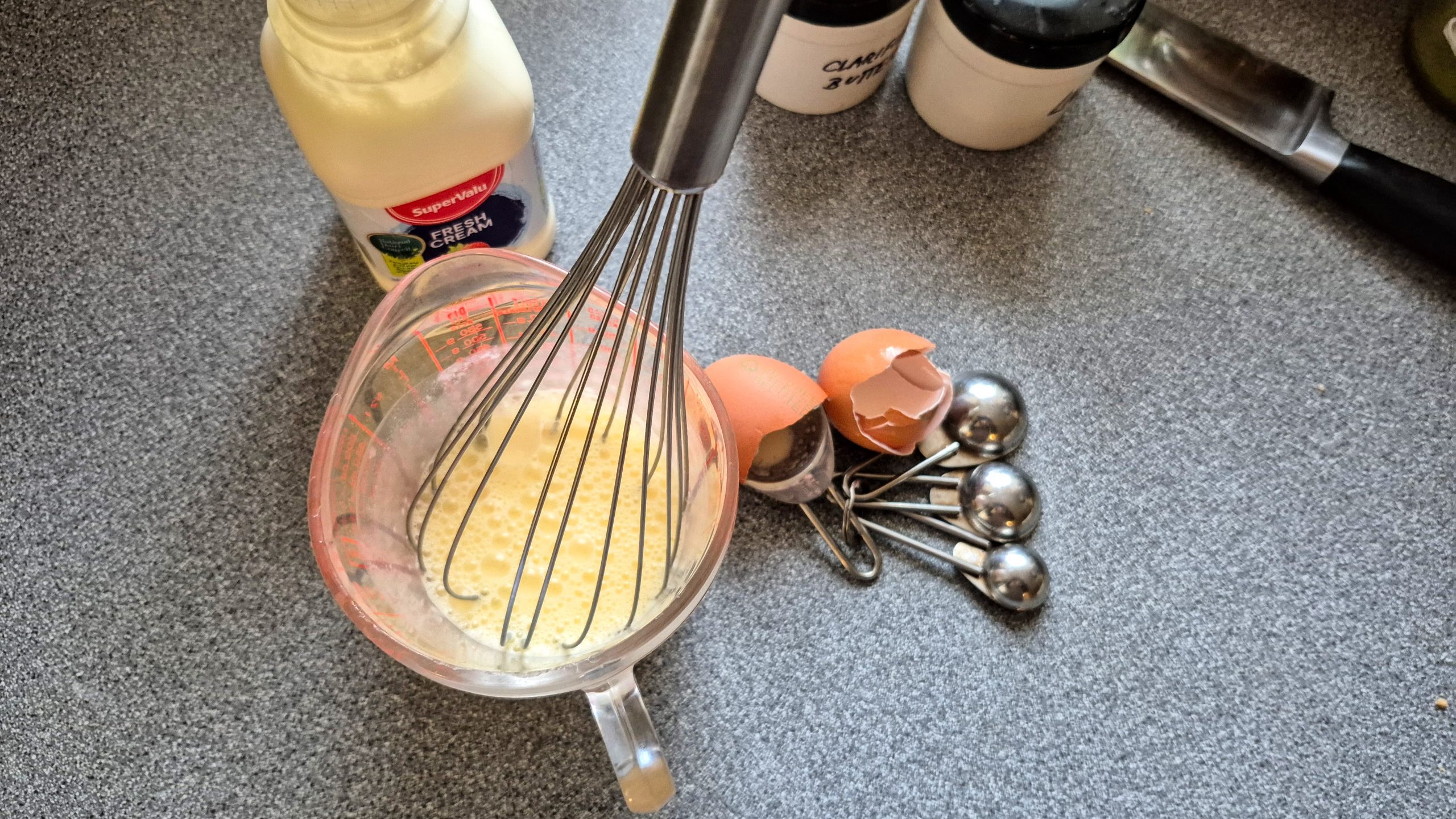The eggs and cream, whisked / beaten together