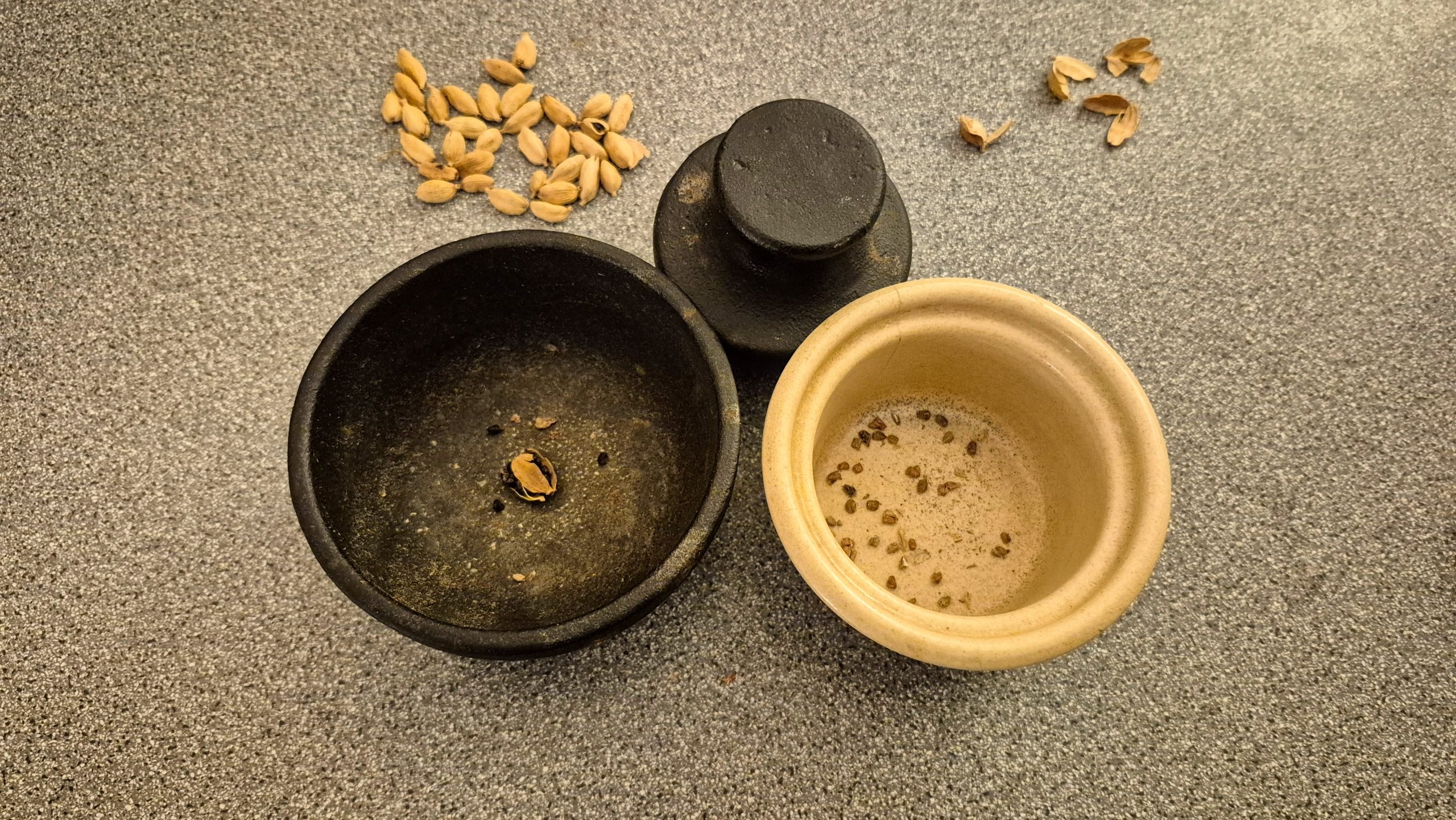 Crushed cardamom pods and the seeds from them