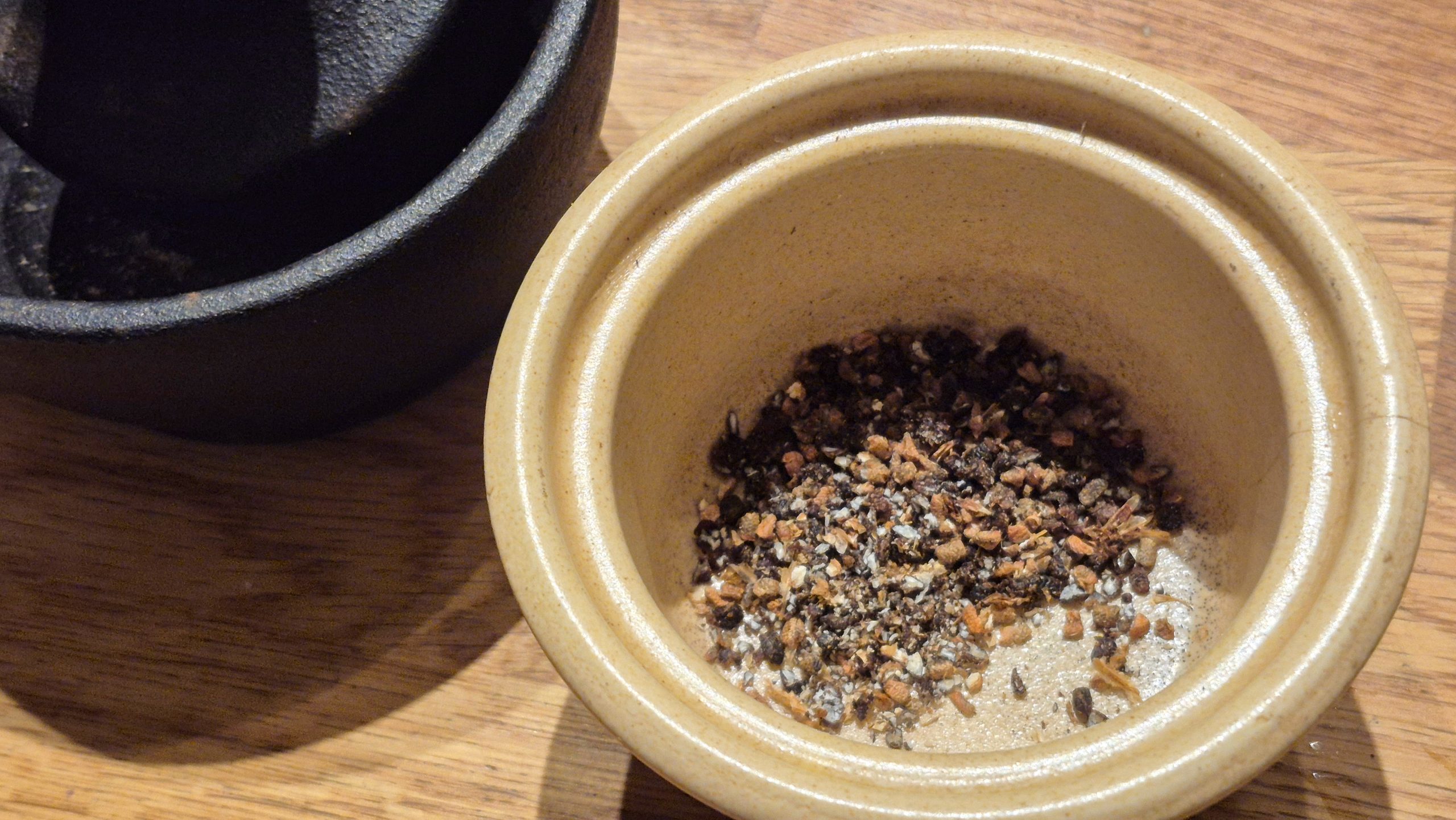 Crushed juniper berries and cardamom seeds